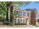 Charming brick townhome with black shutters, a red door, and lush landscaping at 6 Stratford Hall Ne Pl, Atlanta, GA 30342