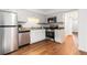 Well-lit kitchen with stainless steel appliances, granite countertops, and white cabinetry at 6 Stratford Hall Ne Pl, Atlanta, GA 30342