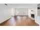 Bright living room boasts hardwood floors, a fireplace and large windows with plantation shutters at 6 Stratford Hall Ne Pl, Atlanta, GA 30342
