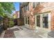 Charming patio with a brick wall, lush greenery, and a serene outdoor space at 6 Stratford Hall Ne Pl, Atlanta, GA 30342