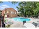 Community pool area with chairs and trees at 6 Stratford Hall Ne Pl, Atlanta, GA 30342