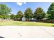 Large backyard featuring a storage shed, privacy fence and fire pit at 895 Roxfield Ct, Buford, GA 30518