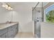 Bathroom features a glass walk-in shower and gray vanity with granite countertops at 895 Roxfield Ct, Buford, GA 30518
