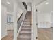 Bright entryway featuring hardwood floors, a staircase, and built-in storage at 895 Roxfield Ct, Buford, GA 30518