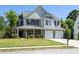 Inviting two-story home featuring a covered porch and a spacious front yard at 895 Roxfield Ct, Buford, GA 30518