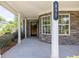 Welcoming front porch with stone accents, white columns, and a decorative house number at 895 Roxfield Ct, Buford, GA 30518