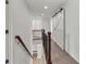 Bright hallway with wood and iron railing and modern barn door at 895 Roxfield Ct, Buford, GA 30518