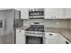 Close-up of kitchen featuring stainless steel appliances and granite countertops at 895 Roxfield Ct, Buford, GA 30518