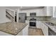 Well-equipped kitchen featuring granite countertops, stainless appliances and wooden floors at 895 Roxfield Ct, Buford, GA 30518