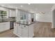 Open-concept kitchen featuring granite countertops, an island and stainless steel appliances at 895 Roxfield Ct, Buford, GA 30518