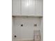 Bright laundry area featuring white cabinets and hookups ready for appliances at 895 Roxfield Ct, Buford, GA 30518