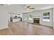 Spacious living room featuring fireplace, open to updated kitchen and light wood flooring at 895 Roxfield Ct, Buford, GA 30518