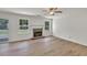 Bright living room featuring a stone fireplace and gleaming hardwood floors at 895 Roxfield Ct, Buford, GA 30518