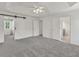 Spacious bedroom features a tray ceiling, ceiling fan, and ensuite bathroom at 895 Roxfield Ct, Buford, GA 30518