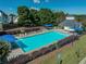 Aerial view of the community pool with lounge chairs and blue umbrellas at 895 Roxfield Ct, Buford, GA 30518