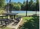 Community tennis courts with picnic table and benches at 895 Roxfield Ct, Buford, GA 30518