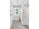 Walk-in closet with custom shelving, storage drawers, and a window for natural light at 895 Roxfield Ct, Buford, GA 30518