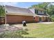 Expansive backyard features a brick house, grassy area, and a concrete patio perfect for outdoor entertaining at 1828 Brandy Woods Se Dr, Conyers, GA 30013