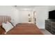 Spacious bedroom featuring carpet flooring and light walls adjacent to the ensuite bathroom at 1828 Brandy Woods Se Dr, Conyers, GA 30013