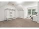Bright bedroom featuring a closet system, carpet flooring, and a large window at 1828 Brandy Woods Se Dr, Conyers, GA 30013