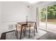 Cozy dining area with a modern table and chairs, a soft rug, and access to the outdoors at 1828 Brandy Woods Se Dr, Conyers, GA 30013