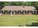Charming ranch-style home with brick facade, black shutters, and a well-maintained front yard at 1828 Brandy Woods Se Dr, Conyers, GA 30013