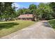 Charming home with a long driveway, manicured lawn, brick facade, and inviting front porch at 1828 Brandy Woods Se Dr, Conyers, GA 30013