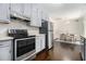 Bright kitchen featuring stainless steel appliances, gray cabinets, and hardwood floors to the dining area at 1828 Brandy Woods Se Dr, Conyers, GA 30013