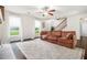 Spacious living room featuring hardwood floors, large windows, fireplace, and a comfortable sofa at 1828 Brandy Woods Se Dr, Conyers, GA 30013