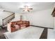 Open living area with a staircase, hardwood floors, large sofa, and a fireplace focal point at 1828 Brandy Woods Se Dr, Conyers, GA 30013
