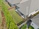 Backyard aerial view with a covered patio, privacy fence, and well-manicured lawn and landscaping at 209 Floral Valley Dr, Woodstock, GA 30188