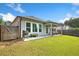A beautiful backyard and patio featuring outdoor seating, lush grass, and a privacy fence at 209 Floral Valley Dr, Woodstock, GA 30188
