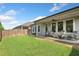 A beautiful backyard and patio featuring outdoor seating, lush grass, and a privacy fence at 209 Floral Valley Dr, Woodstock, GA 30188