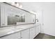 This bathroom offers dual sinks, quartz counters, a huge mirror and stylish hardware and a view of the shower at 209 Floral Valley Dr, Woodstock, GA 30188
