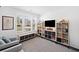 Bright bedroom featuring large windows with plantation shutters, built-in shelving, and cozy gray armchairs at 209 Floral Valley Dr, Woodstock, GA 30188