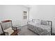 Serene bedroom with soft carpeting, a crib, and a comfortable daybed, bathed in gentle light at 209 Floral Valley Dr, Woodstock, GA 30188