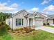 Inviting brick exterior with landscaped front yard, a two-car garage, and charming architectural details at 209 Floral Valley Dr, Woodstock, GA 30188