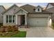 Charming single-Gathering home featuring brick facade, manicured landscaping, and attached two-car garage at 209 Floral Valley Dr, Woodstock, GA 30188