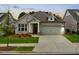 Charming single-story home featuring a well-manicured lawn and a two-car garage with a beautiful flower bed at 209 Floral Valley Dr, Woodstock, GA 30188