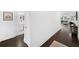 Inviting hallway with gleaming hardwood floors leading to a bright, open-concept living area and bathroom at 209 Floral Valley Dr, Woodstock, GA 30188