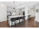 Modern kitchen boasts a center island with seating, pendant lighting, stainless appliances, and sleek gray cabinets at 209 Floral Valley Dr, Woodstock, GA 30188