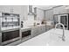 Well-appointed kitchen featuring stainless appliances, gray cabinetry, and a large, bright countertop at 209 Floral Valley Dr, Woodstock, GA 30188
