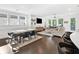 Spacious open-concept living and dining area featuring hardwood floors, large windows, and modern furnishings at 209 Floral Valley Dr, Woodstock, GA 30188