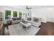 Bright living room with large windows, hardwood floors, and neutral decor for a cozy atmosphere at 209 Floral Valley Dr, Woodstock, GA 30188