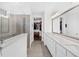 An expansive main bathroom with dual vanities, gray tile floors and an entrance to the closet is shown at 209 Floral Valley Dr, Woodstock, GA 30188