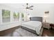 Serene main bedroom with plantation shutters, hardwood floors, ceiling fan, and ample natural light at 209 Floral Valley Dr, Woodstock, GA 30188