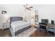 Cozy main bedroom featuring hardwood floors, neutral decor, and a ceiling fan at 209 Floral Valley Dr, Woodstock, GA 30188