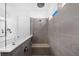 This modern shower offers gray tile walls, stylish fixtures, a glass partition and a built in bench at 209 Floral Valley Dr, Woodstock, GA 30188
