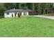 Attractive one-story brick home with a green lawn and a long driveway at 3175 West Manor Sw Cir, Atlanta, GA 30311