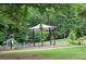 Neighborhood playground featuring a sunshade, fitness machines, and a lush green setting at 3175 West Manor Sw Cir, Atlanta, GA 30311
